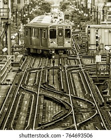 Train on elevated tracks within buildings at the Loop, Chicago City Center - Black Gold BW Artistic Effect - Chicago, Illinois, USA