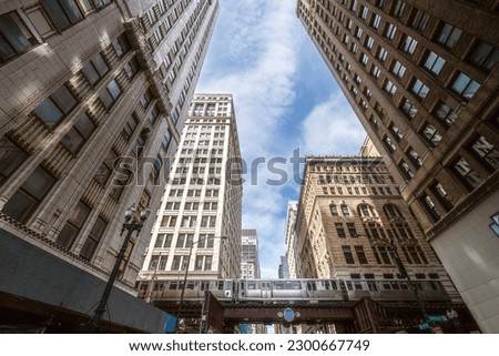 Train on elevated tracks within buildings at the Loop, Glass and Steel bridge between buildings, Chicago City Center, Chicago, Illinois, USA