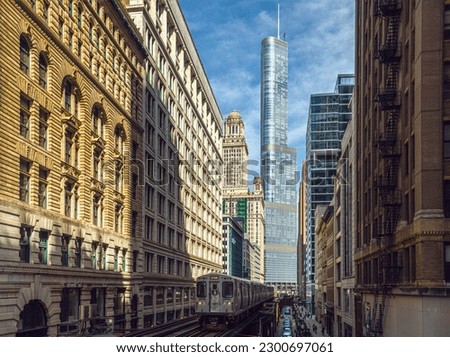 Train on elevated tracks within buildings at the Loop, Glass and Steel bridge between buildings, Chicago City Center, Chicago, Illinois, USA