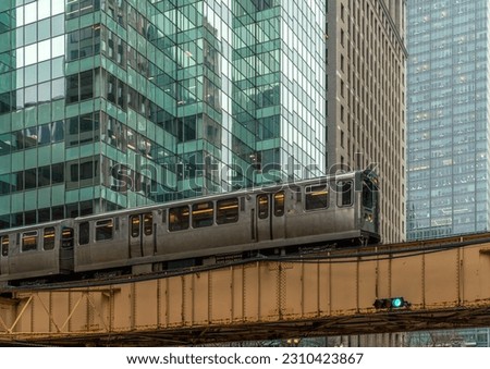 Train on elevated tracks within buildings at the Loop, Glass and Steel bridge between buildings, Chicago City Center, Chicago, Illinois, USA