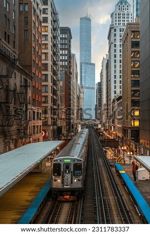 Train on elevated tracks within buildings at the Loop, Glass and Steel bridge between buildings, Chicago City Center, Chicago, Illinois, USA
