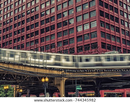 Train on elevated tracks within buildings at the Loop, Chicago City Center - Long Exposure, Dark Cross Processing Artistic Effect - Chicago, Illinois, USA
