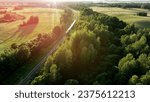 Train on railway in motion. Traveling on Passenger train on railway from forest, aerial view. Train with passenger cars rides. Drone view of an passenger locomotive with wagons in moving on railroad