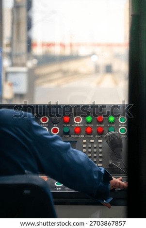 Train Operator Operating the Control Panel Inside the Cab