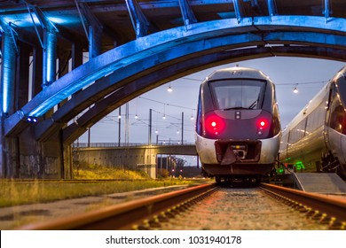 Train Paring under lit bridge