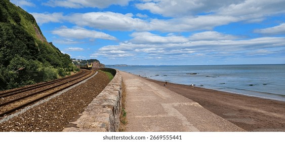 Train passing alongside seaside in Devon 