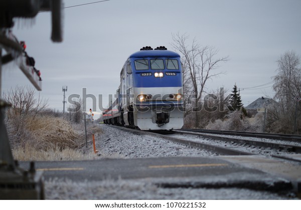 Train passing the crossroad during the autumn in\
montreal quebec canada