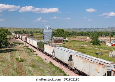 Train Passing Old Grain Elevator In South Dakota