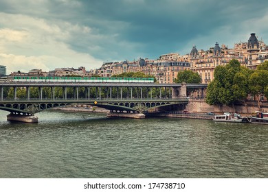 Train passing on famous Pont de Bir-Hakeim bridge across Seine River in Paris, France (toned). - Powered by Shutterstock