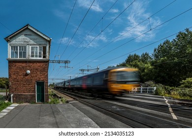 Train Passing Signal Box With Blue Sky