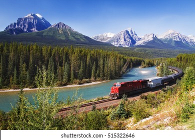 Train passing through Bow valley under the surveillance of mighty Rocky Mountains. - Powered by Shutterstock