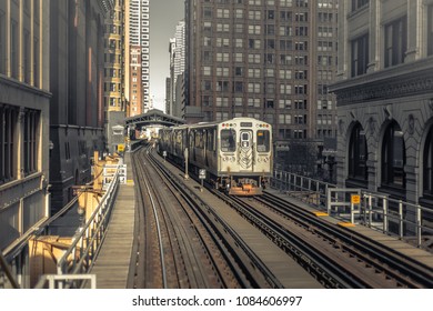 Train passing through loop in downtown Chicago in the early morning