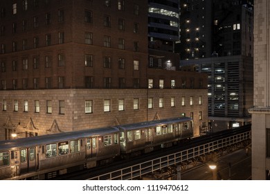 Train pausing at night with lights