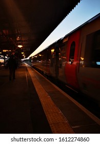 Train Pulling up to Dimly lit Station Platform