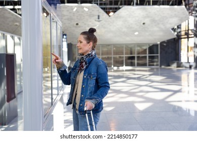 Train Ride. The Woman Checks The Train Timetable.