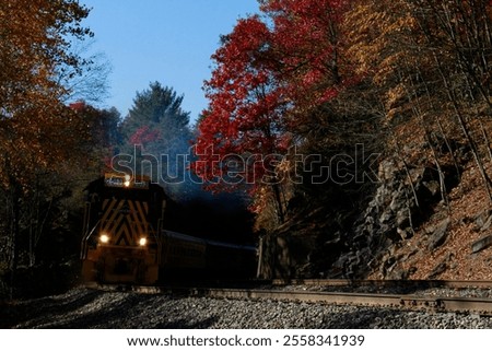 train rounding a mountain corner in the fall