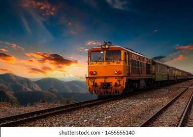 The train is running to the destination station when the sun is going down in the evening in a beautiful natural way in Thailand. - Powered by Shutterstock