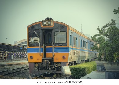  train station with a train about to leave while the next train waits to come in.