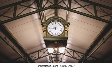 train station clock hanging from ceiling