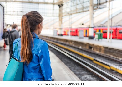 Train station morning commute woman going to work waiting for train to arrive. People on public transport platform . Commuting on rush hour. View of businesspeople and rails city lifestyle. - Powered by Shutterstock