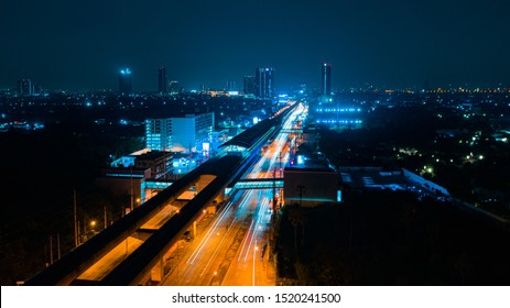 Train Station, Rail Track And Conductor Rail Transportation, Aerial Top View, Road Expressway Traffic Highway Roundabout Transportation With Moving Cars And Railway Tracks On Which The Train Rides