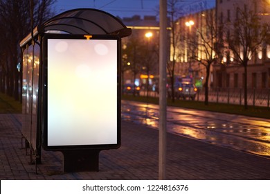 Train Stop Bus Shelter, With Advertising Billboard Light Advertisement For Advertising. Outdoor Advertising Luminous In The Night City. Layout For Advertising. Empty White Field. Bus Stop