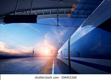 Train Stop At Railway Station With Sunset