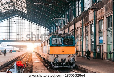 Train stop at railway station with sunset. Budapest Keleti railway station. Travelling by train concept. 