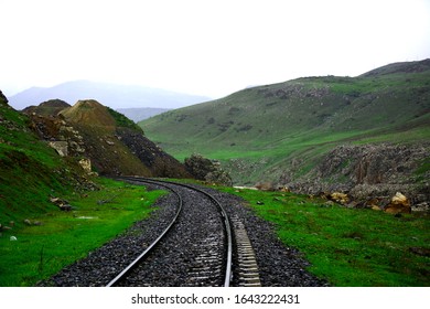 train track between the mountains