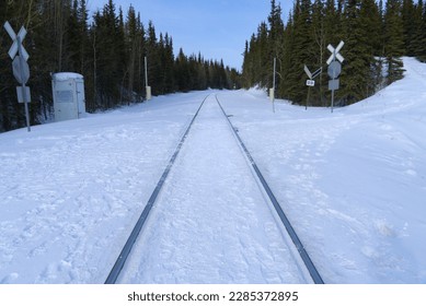 Train track in the snow covered the ground.