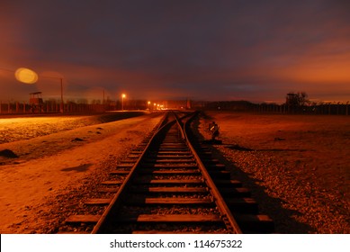 Train Tracks At Birkenau Concentration Camp At Night.