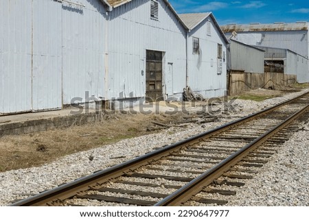 Train tracks running along the back of tin metal industrial buildings in Birmingham Alabama