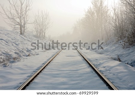 Train tracks in winter mist