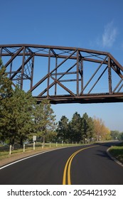 Train Trestle Over A Winding Road In Bismarck, North Dakota.