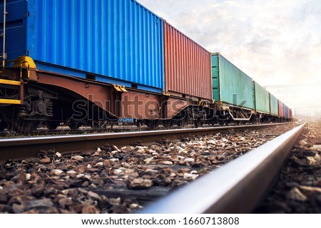 Train wagons carrying cargo containers for shipping companies. Distribution and freight transportation using railroads.