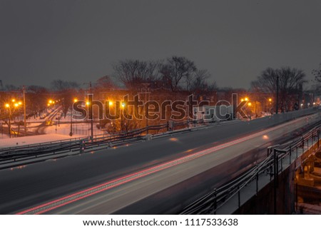 Train whipping through frame with snow and lights