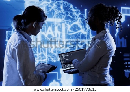 Trained programmers brainstorm ways to use AI cognitive computing to extract usable information from complex data. Adept employees implement artificial intelligence to process massive datasets