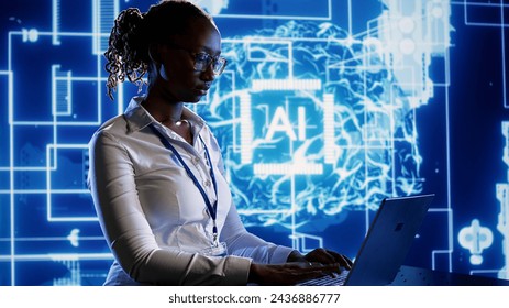 Trained specialist using laptop to maintenance artificial intelligence neural networks made up of interconnected nodes. System administrator using AI system aiding in processing information