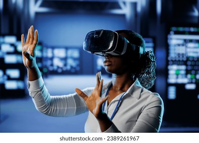 Trained technician in data center uses virtual reality to prevent system overload. Experienced VR headset user in server room ensuring enough network bandwidth for smooth operations