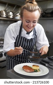 Trainee Chef Working In Restaurant Kitchen