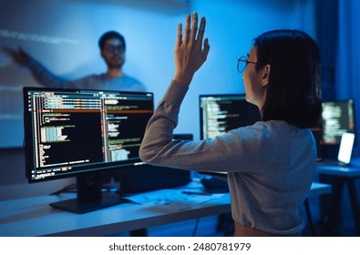trainee developer hand up to ask speaker about software coding project presentation at night in office