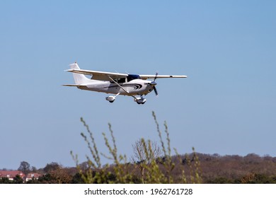 A Trainer Aircraft Seen In Action At An Airfield. 