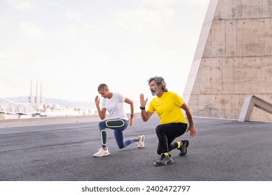 trainer doing squat training to a senior man