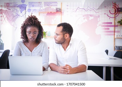 Trainer explaining specifics and virtual statistic graphics. Business man and woman in casual sitting at workplace, using laptop and talking. Corporate training concept