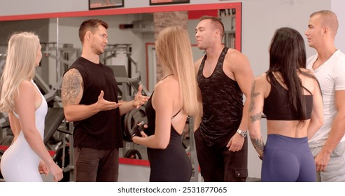 The trainer gives information to the students before training in the gym Group interactions occurring gym environment, highlighting both culture active social engagement  - Powered by Shutterstock