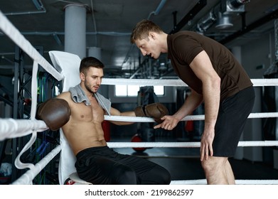 Trainer giving tips to boxer before next round - Powered by Shutterstock