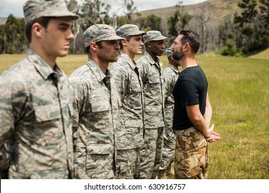 Trainer giving training to military soldier at boot camp - Powered by Shutterstock
