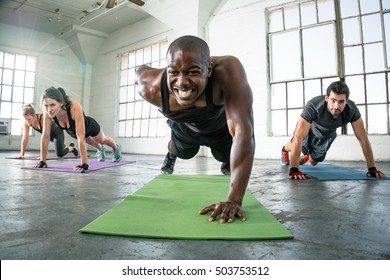 Trainer At Gym Leads Class Group In Cross Fit Challenge Gritting Teeth Full Of Drive Vitality