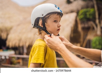 Trainer Helps The Boy To Wear Helmet Before Training Skate Board