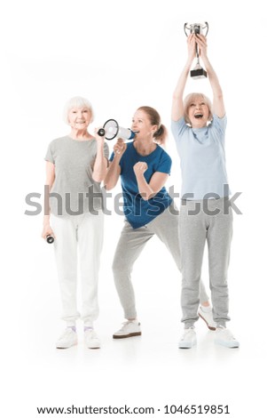 Trainer with megaphone and sportswomen with dumbbells and trophy isolated on white